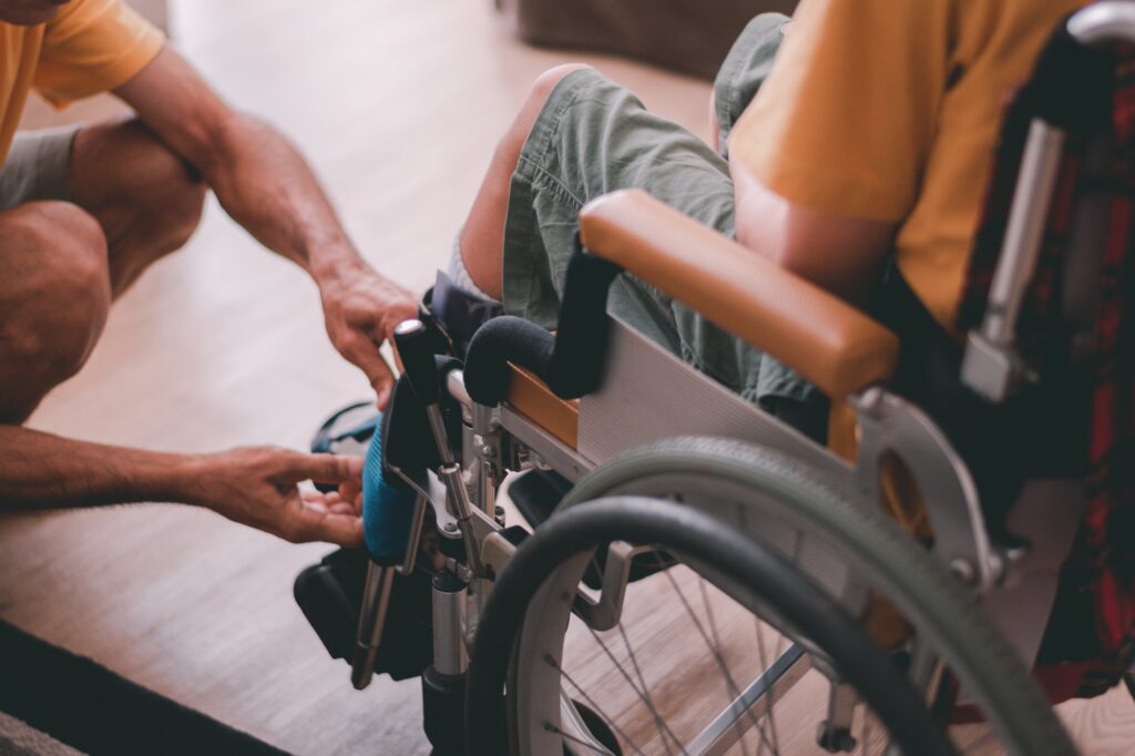 Disabled child on wheelchair and parent to take care by love.