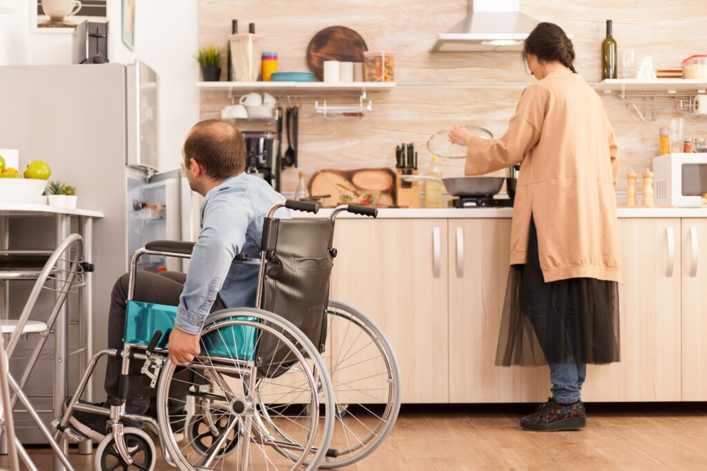 Disabled man opens refrigerator