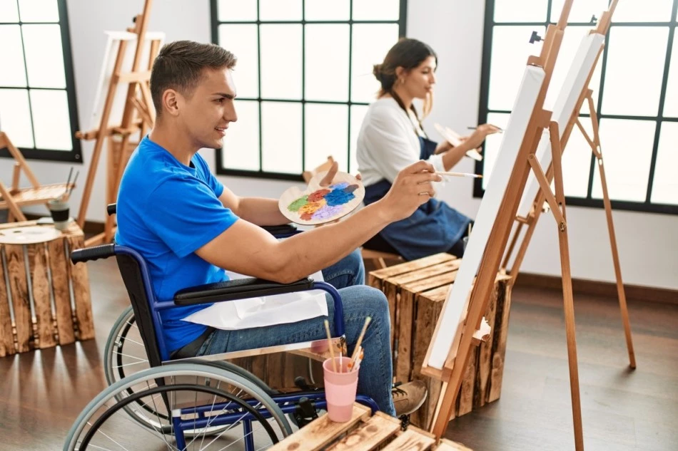 Disabled boy in wheelchair in art class