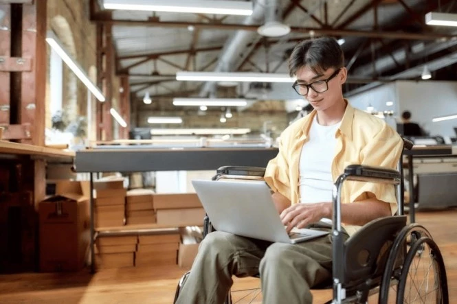 Man in wheelchair on laptop