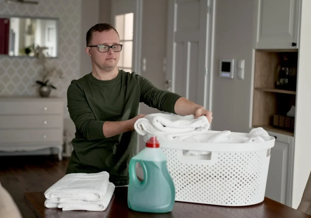 Disabled man doing laundry in home
