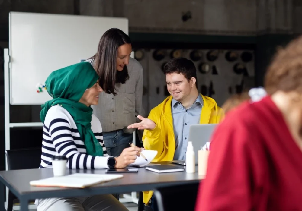 Disabled boy talking with colleagues